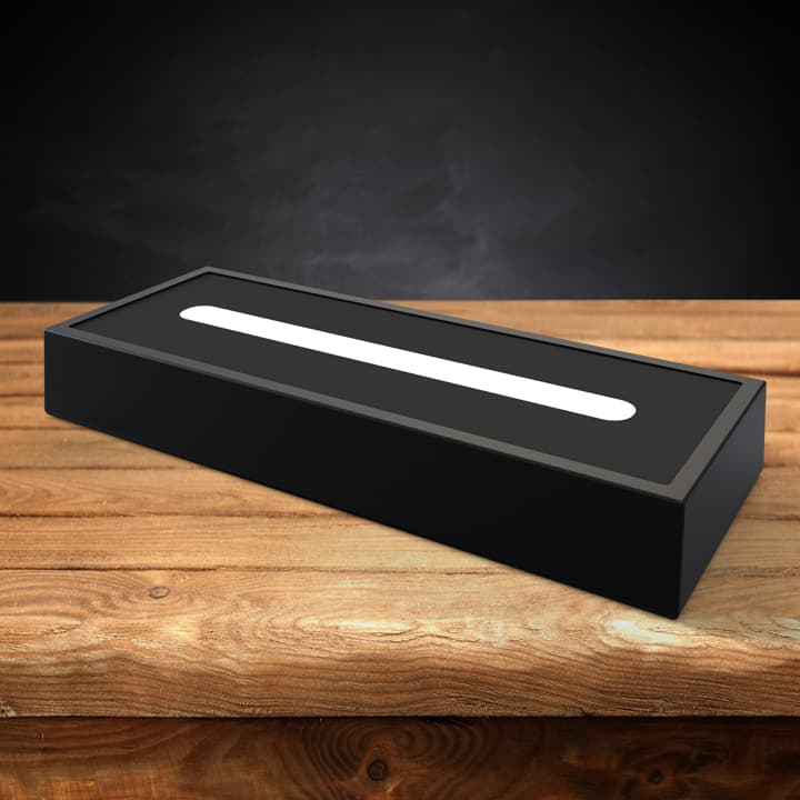 Dark wood LED light base on a wooden table.