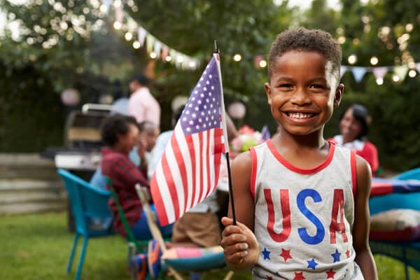Happy child waving the American flag