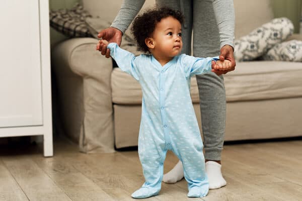 A baby taking his first steps