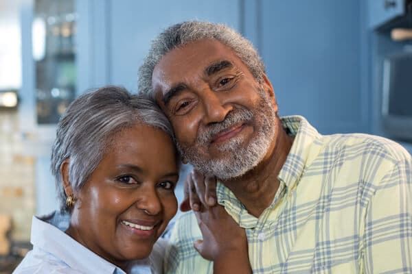 Happy old couple leaning on each other